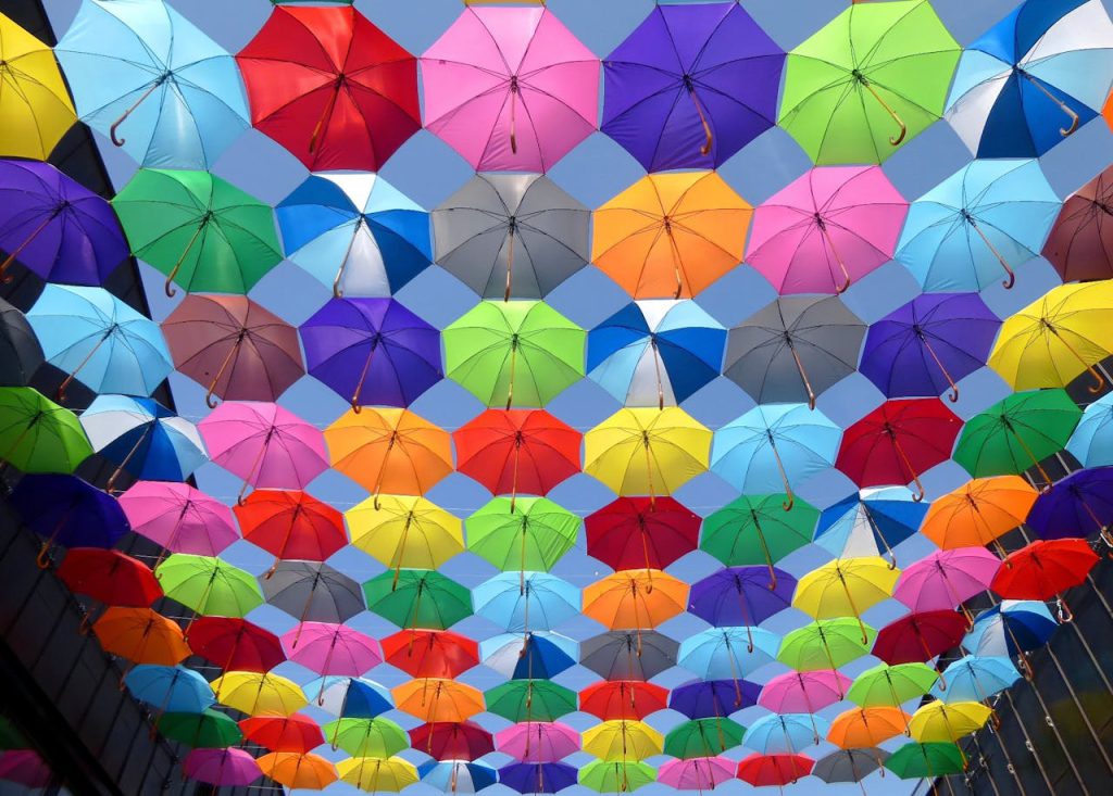 color-umbrella-red-yellow-163822 Bright and colorful arrangement of umbrellas creating a vibrant canopy.
